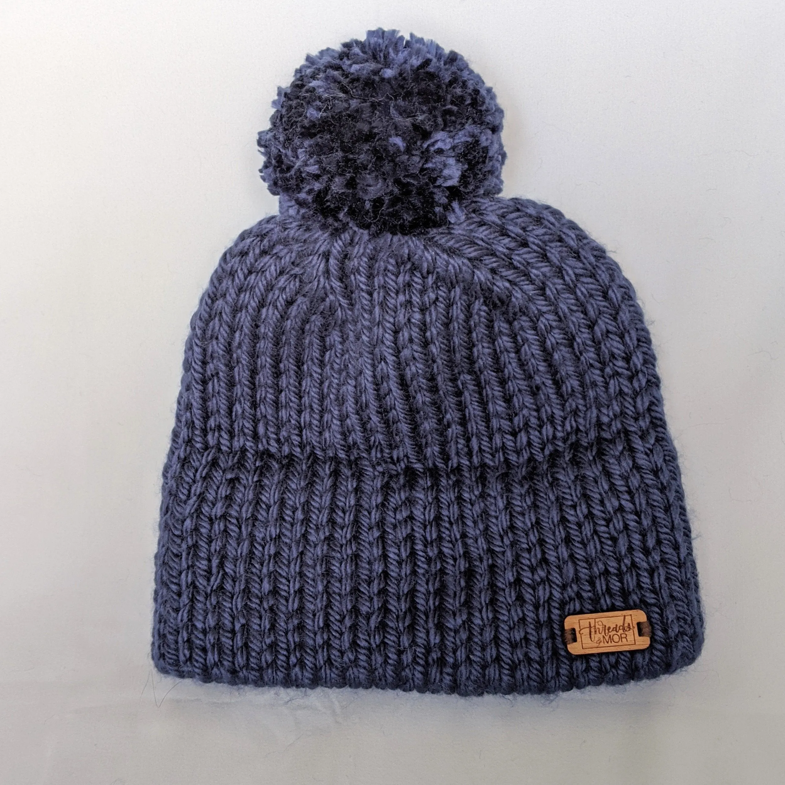 Navy double brim knit hat with yarn pompom
