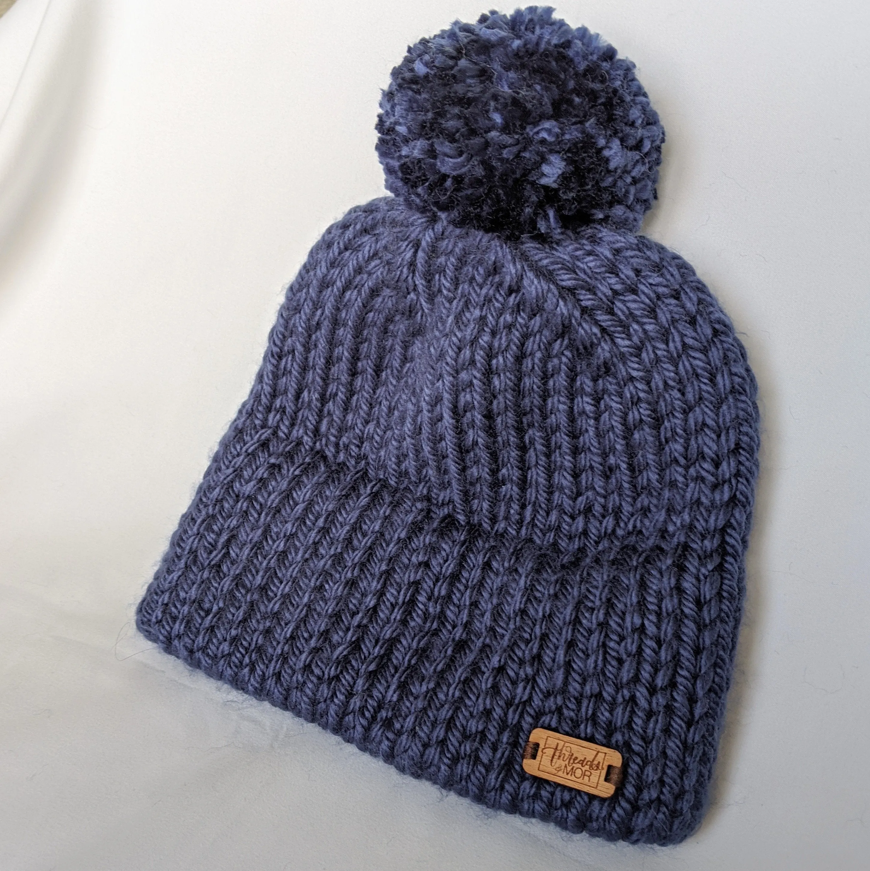 Navy double brim knit hat with yarn pompom